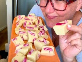 Christmas Cookie Dough Fudge holding piece