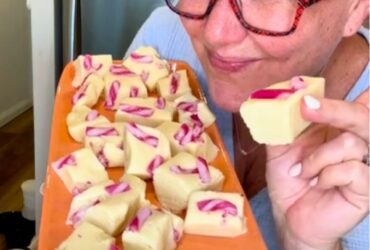 Christmas Cookie Dough Fudge holding piece