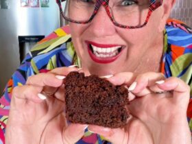 Fudgy Chocolate Zucchini Cake holding slice