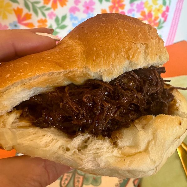 Slow Cooked Pulled Beef Slow Cooked Pulled Beef holding on roll