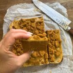 Biscoff Cheesecake Slice holding in hand