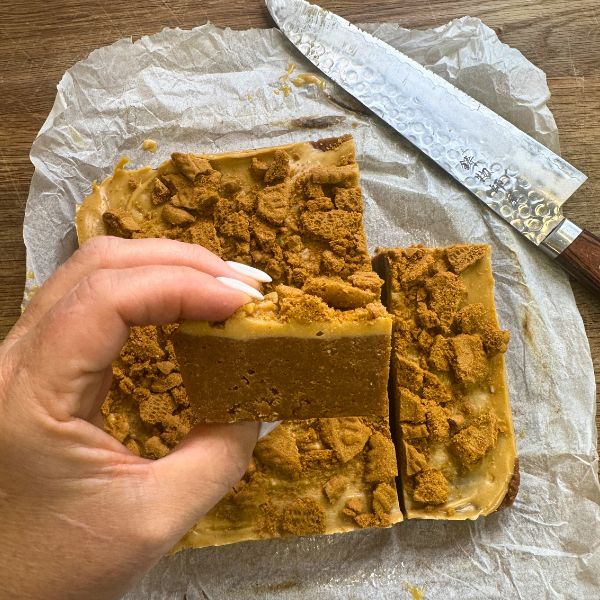 Biscoff Cheesecake Slice holding in hand