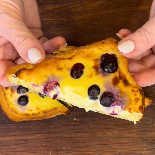 Air Fryer Custard Toast holding Air Fryer Custard Toast cut in half and holding