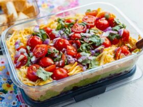 Mexican Layer Dip with Tortilla Chips served in container