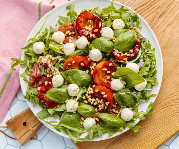 Peach Bocconcini Salad with Honey, Basil and Proscuitto on plate