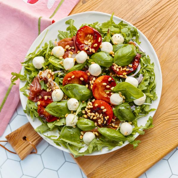 Peach Bocconcini Salad with Honey, Basil and Proscuitto on plate