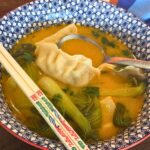 red curry dumpling soup in bowl