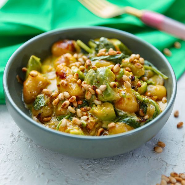 Avocado Gnocchi with Spinach and Pinenuts Avocado Gnocchi with Spinach and Pinenuts served in bowl