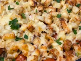 Pesto Chicken Bacon Loaded Potatoes cooked in dish