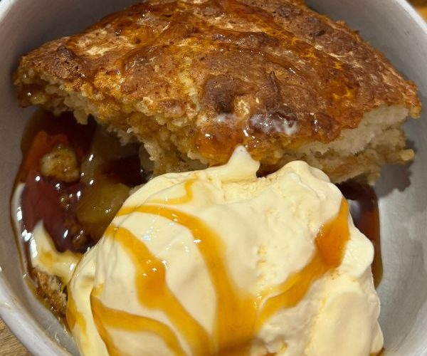 Apple Pudding served in bowl with icecream