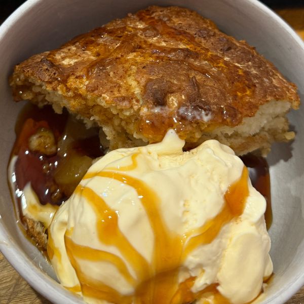 Apple Pudding served in bowl with icecream